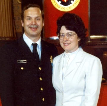 Charles was promoted to Lieutenant in 1990 and is seen here at the promotional ceremony wearing his full fire dress uniform along with his wife Carol who is wearing a white blouse and blazer.