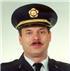 A head shot of Charles Legg in his fire department uniform and hat.